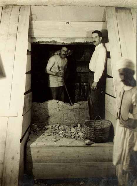Howard Carter and Lord Carnarvon stand in the partially dismantled doorway between the tomb’s antechamber and the burial chamber. (Public domain)