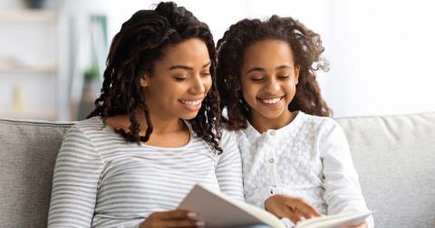 Mother and daughter reading together. (Prostock-studio /Adobe Stock)