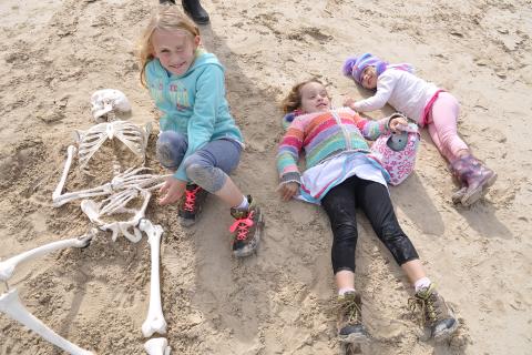 Featured Image: The John children at Trousers Point on Flinders Island, Tasmania, recreating the burials at Lamanai, an ancient Maya site in Belize. Source: Courtesy of Jennifer and Alexander John